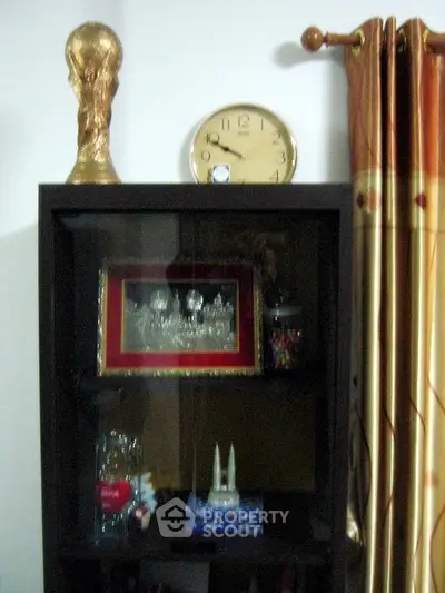 Stylish living room with elegant display cabinet and decorative items, perfect for modern home decor.