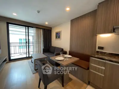 Modern living room with cozy seating and dining area in stylish apartment.