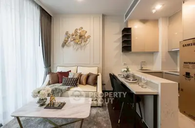 Elegant living room with modern kitchen in open layout, featuring stylish decor and natural light.