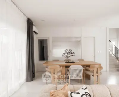 Elegant dining area with modern furniture and natural light in a stylish home interior.