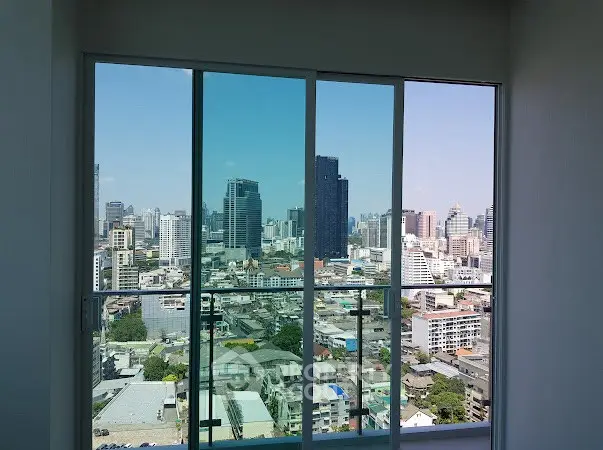 Stunning cityscape view from high-rise apartment window, showcasing urban skyline.