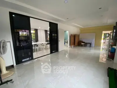 Spacious open-plan living area with modern design and large windows for natural light.