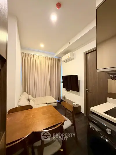 Cozy living room with modern furniture and air conditioning in a compact apartment.