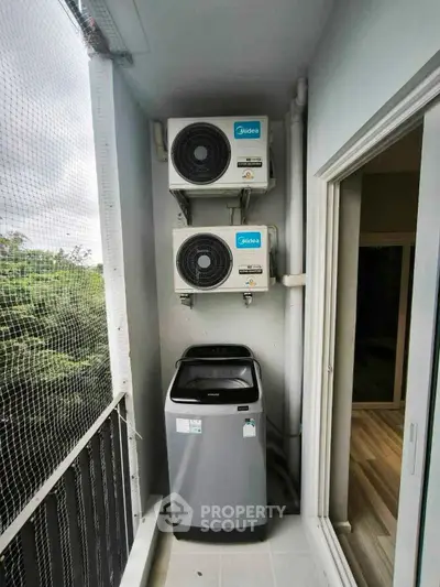 Compact balcony with washing machine and air conditioning units, ideal for efficient urban living.