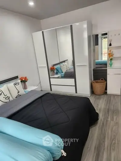 Modern bedroom with stylish decor and ample storage space