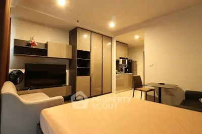 Modern studio apartment with stylish furniture and open kitchen layout