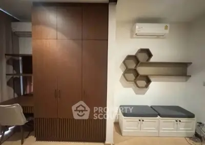 Modern interior with stylish shelving and air conditioning in a cozy living space.