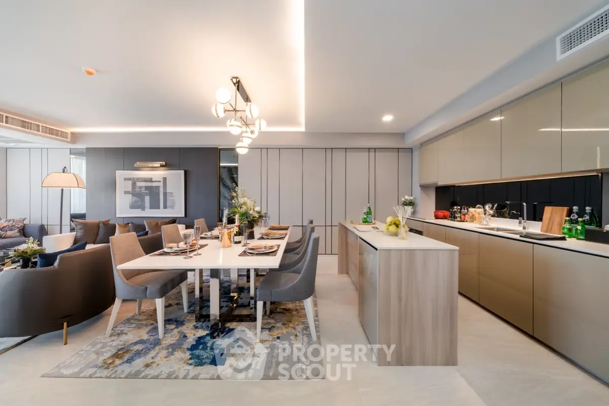 Luxurious open-plan living room and kitchen with modern decor and elegant lighting.