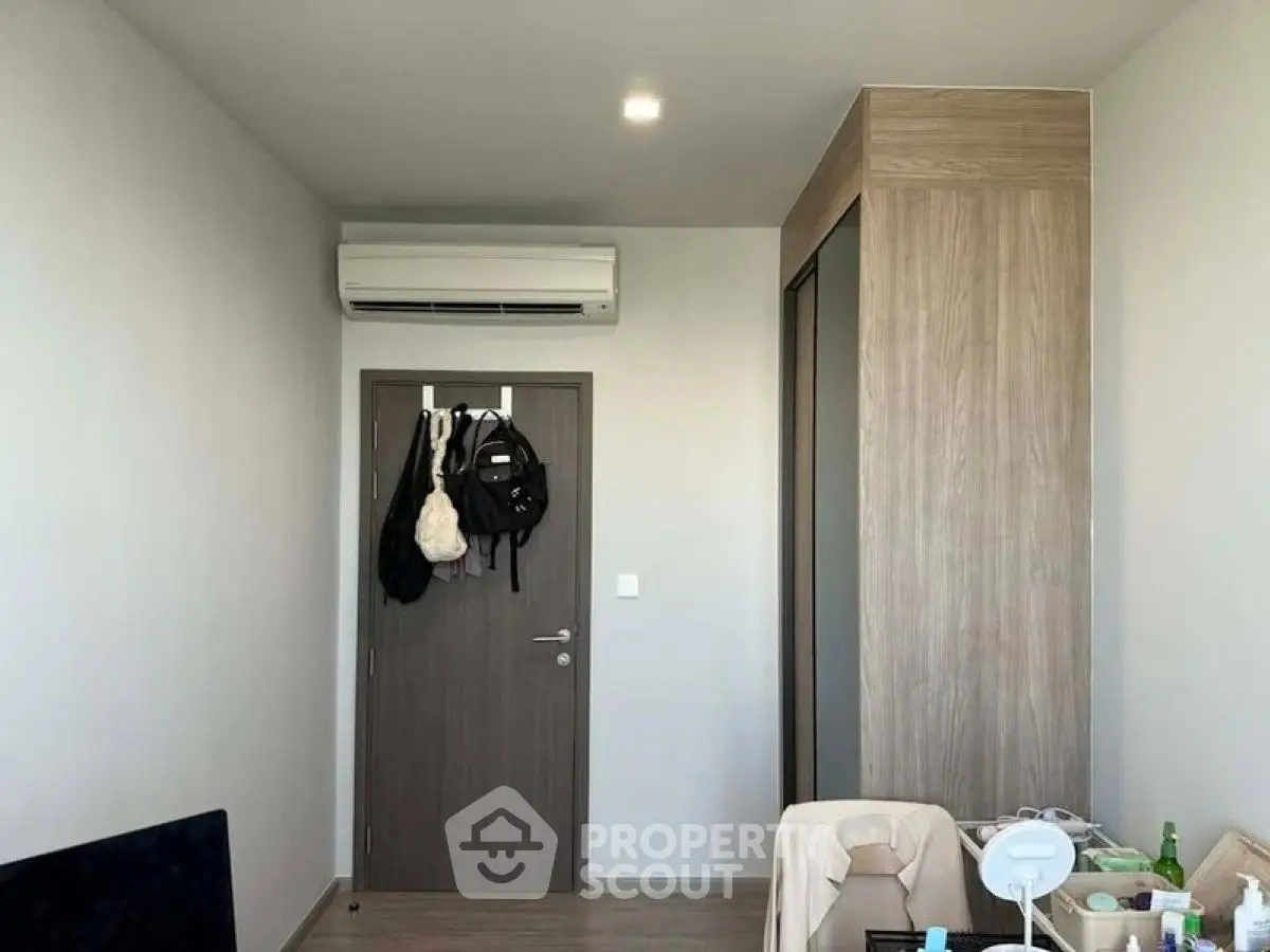 Modern bedroom with air conditioning and built-in wardrobe