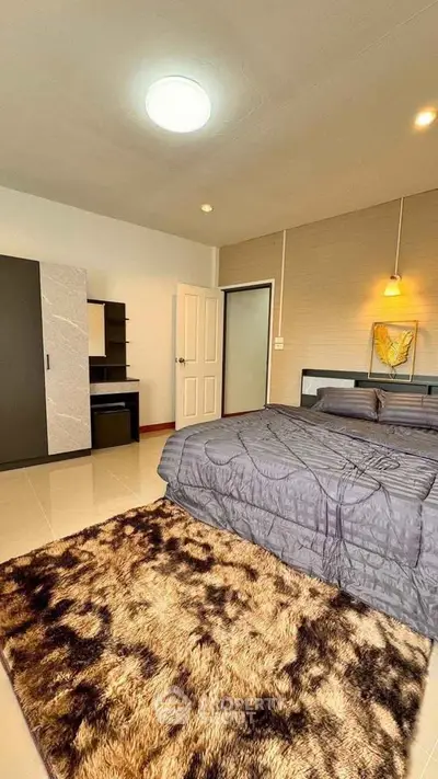 Cozy bedroom with modern decor, plush rug, and stylish lighting for ultimate comfort and relaxation.