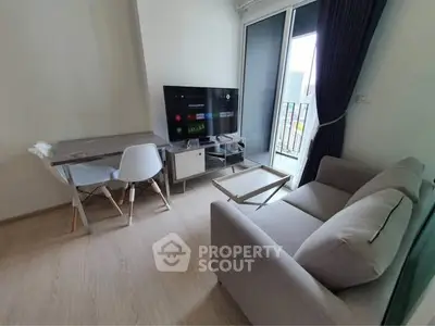 Modern living room with sleek furniture and city view balcony.