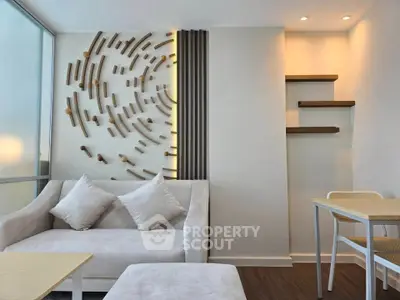 Modern living room with stylish wall decor and cozy seating area