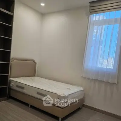 Cozy bedroom with single bed and window view in modern apartment