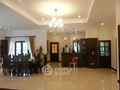 Spacious living room with elegant dining area and modern lighting in a luxurious home.
