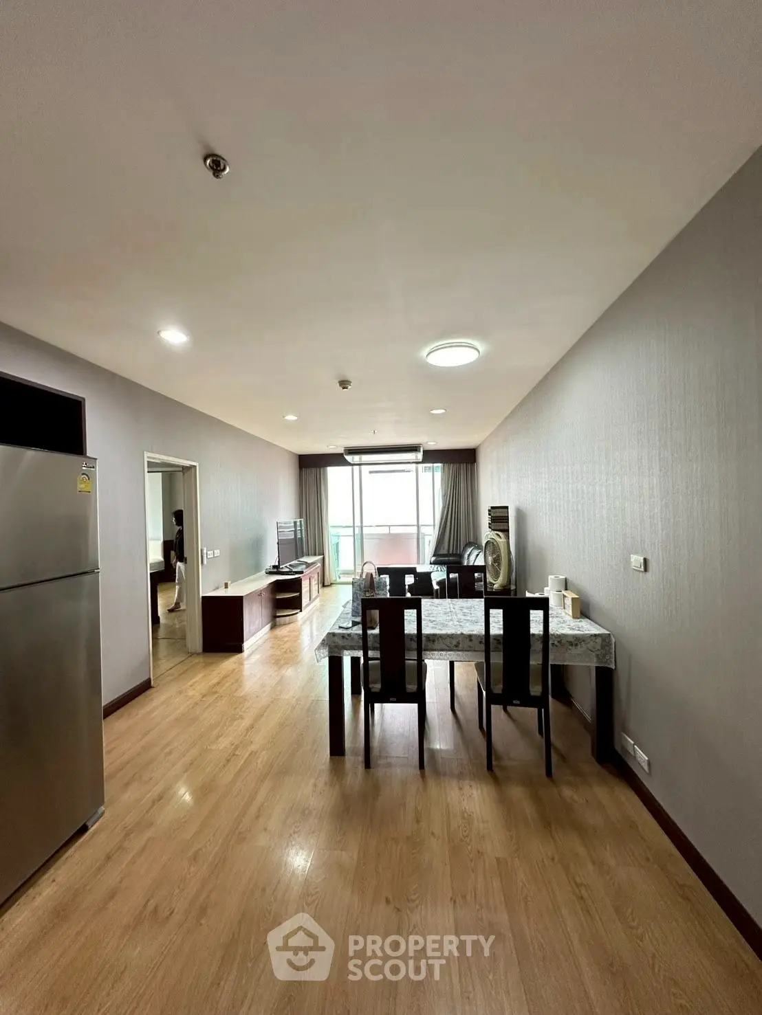 Spacious dining area with modern decor and natural light in a stylish apartment.