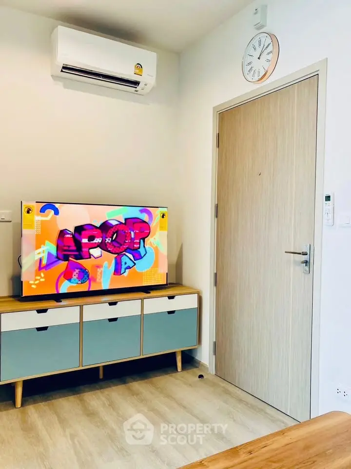 Modern living room with stylish TV unit and wall-mounted air conditioner