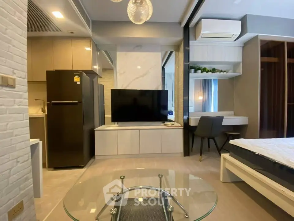 Modern studio apartment with sleek design, featuring a cozy living area, compact kitchen, and stylish workspace.