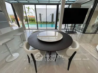 Luxurious modern living room with pool view and elegant dining area