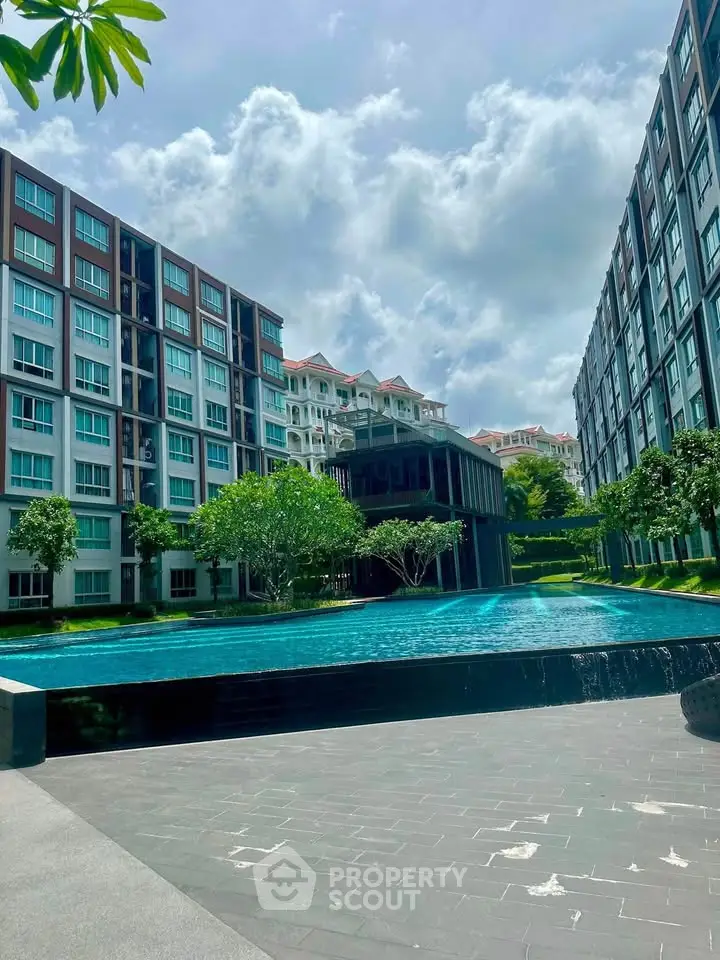 Luxurious condominium with stunning pool and lush greenery, perfect for modern living.