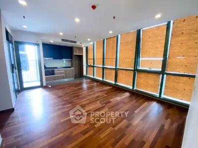 Spacious modern living room with wooden flooring and large windows