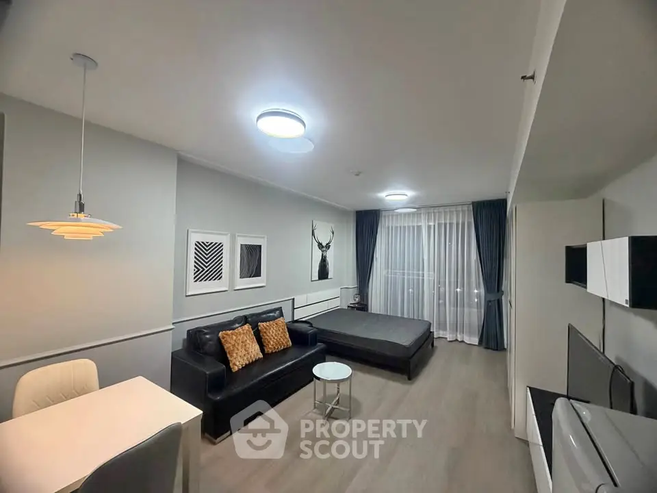 Modern studio apartment with stylish decor and open layout, featuring a cozy living area and elegant lighting.