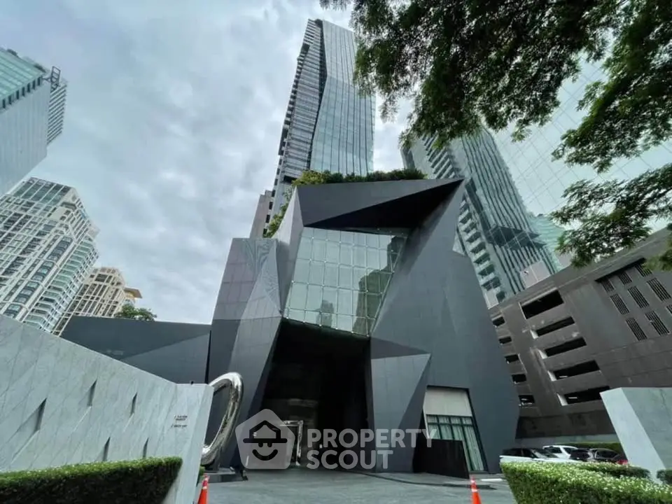 Stunning modern architectural building with sleek design and towering glass facade in urban setting.