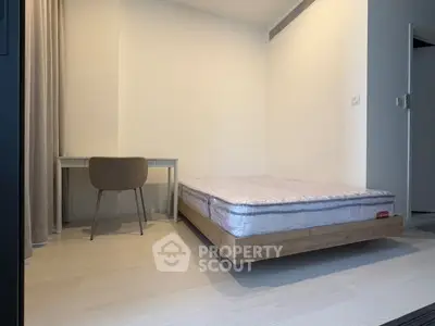 Minimalist bedroom with modern bed and study desk, perfect for urban living.