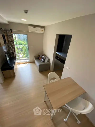 Modern living room with balcony view and stylish decor in a cozy apartment.