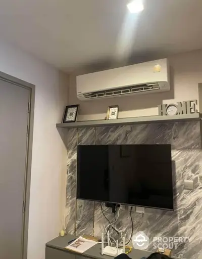 Modern living room with air conditioning and wall-mounted TV