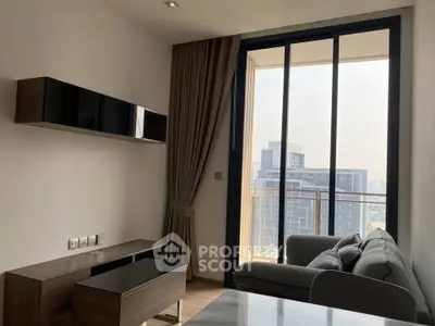 Modern living room with large window and city view, featuring sleek furniture and elegant decor.