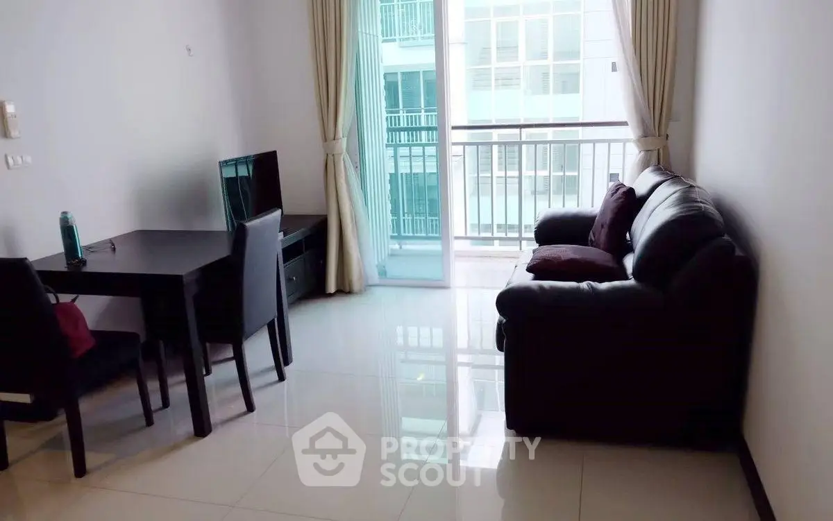 Modern living room with sleek furniture and balcony view