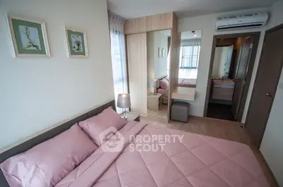 Cozy bedroom with pink bedding, mirrored wardrobe, and modern decor