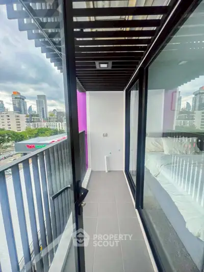 Modern urban balcony with city view and sleek glass railing