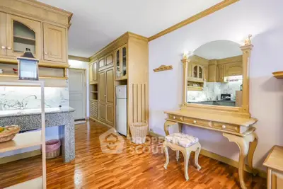 Charming kitchen with wooden cabinetry and elegant vanity in cozy apartment
