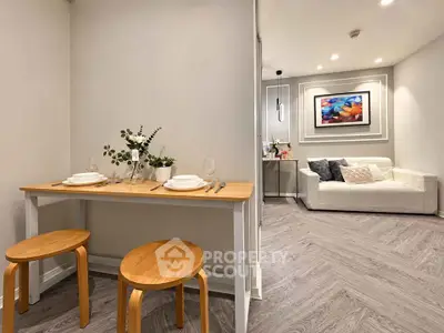 Modern open-plan living room with stylish dining area and cozy seating, perfect for urban living.