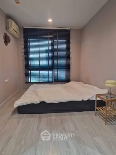 Modern minimalist bedroom with large window and air conditioning