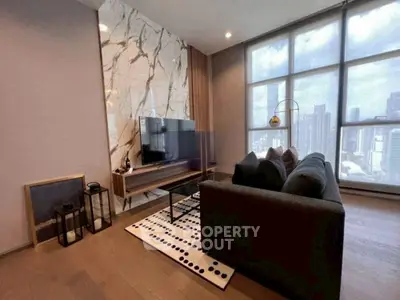 Modern living room with city view, stylish decor, and natural lighting.