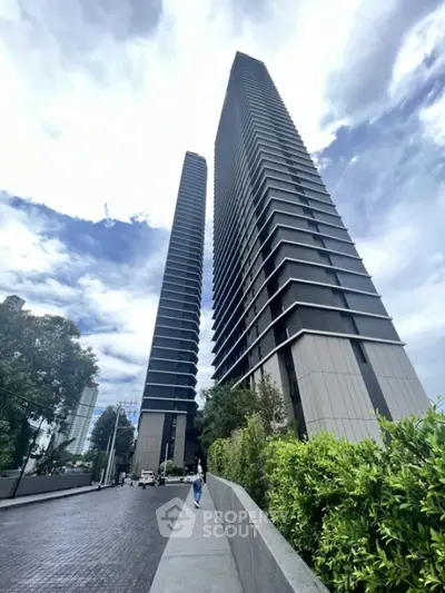 Modern high-rise buildings with sleek design and lush greenery in urban setting