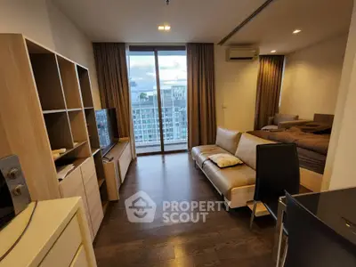 Modern living room with large windows and city view, featuring stylish furniture and cozy ambiance.