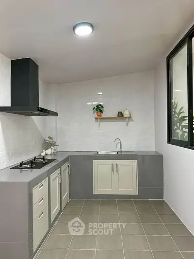 Modern kitchen with sleek design, featuring gas stove and ample cabinetry, perfect for culinary enthusiasts.