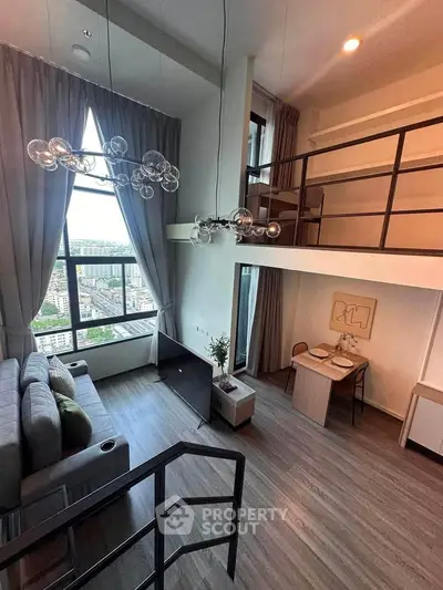 Stunning loft apartment with high ceilings and panoramic city views, featuring modern decor and a cozy dining area.