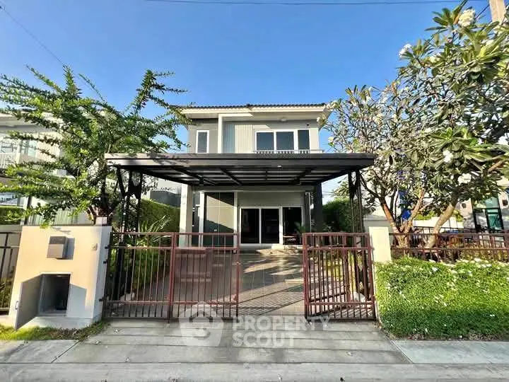Charming two-story house with modern design and lush garden in a serene neighborhood.