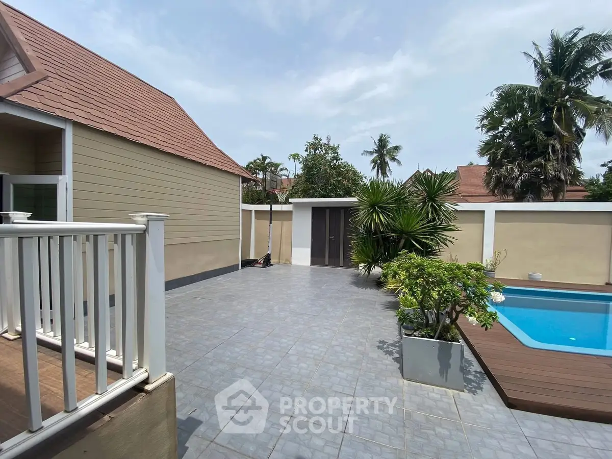 Spacious backyard with pool and tropical landscaping in a modern home.