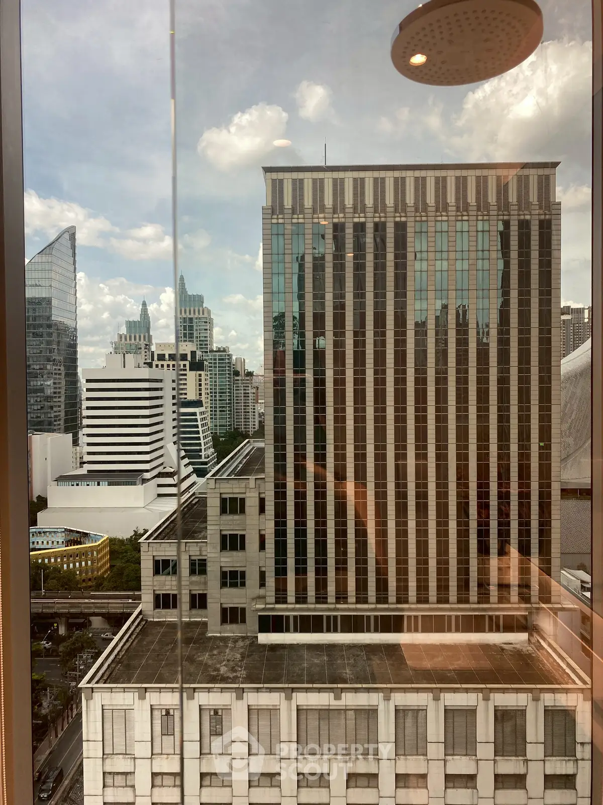 Stunning cityscape view from a high-rise building window, showcasing modern architecture and skyline.