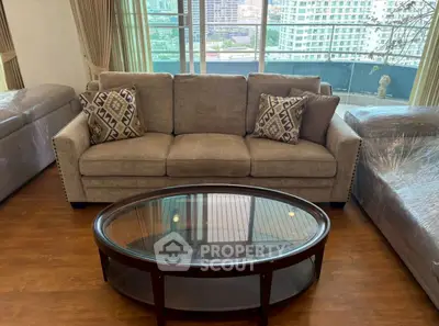 Spacious living room with elegant sofa and city view, perfect for urban living.