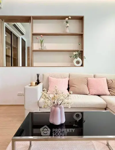 Chic living room with modern decor, plush sofa, and elegant shelving for a cozy ambiance.