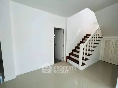 Modern minimalist interior with staircase and sleek tile flooring