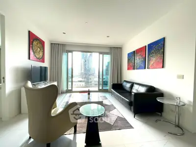 Modern living room with city view, stylish furniture, and vibrant artwork, perfect for urban living.