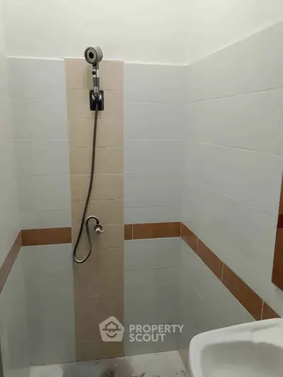 Minimalist bathroom with modern shower and tiled walls
