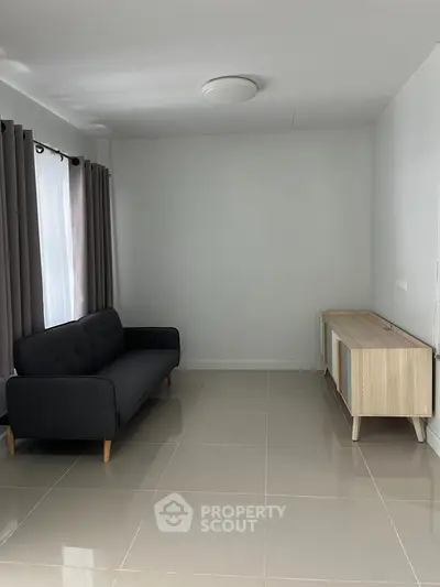 Minimalist living room with sleek sofa and modern cabinet